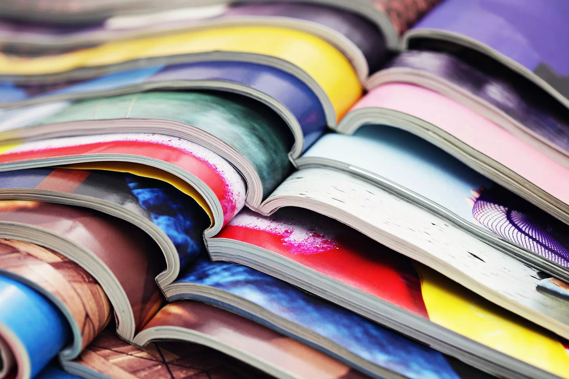 Open magazines fanned out to show colorful inside pages