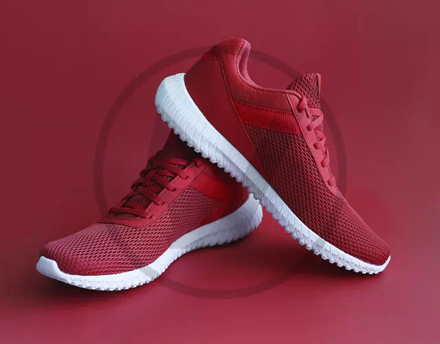 Product photo of red sneakers with a semi-transparent round logo mark
