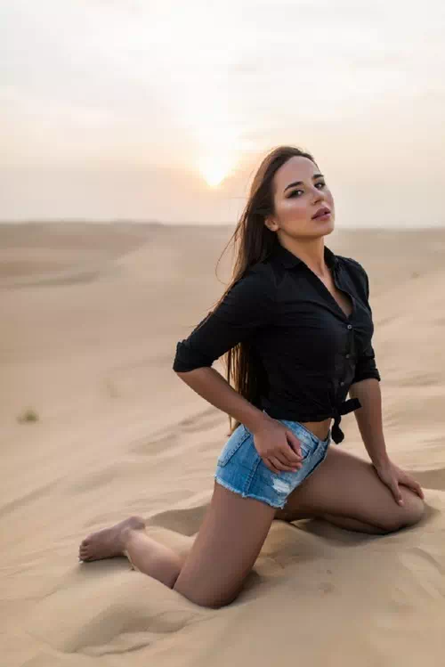 Kneeling on Sand with Arms Open Wide Kneeling on Sand with Arms Open Wide