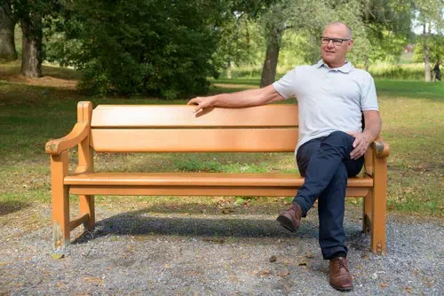 Sitting on a Bench with Legs Crossed Sitting on a Bench with Legs Crossed