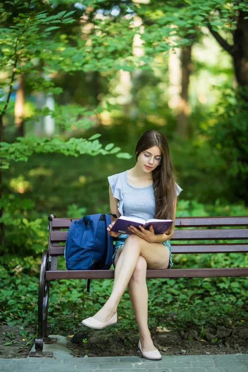 Sitting on a Park Bench and Reading a Book Sitting on a Park Bench and Reading a Book